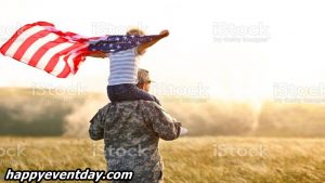 Excited child sitting with american flag on shoulders of father reunited with family